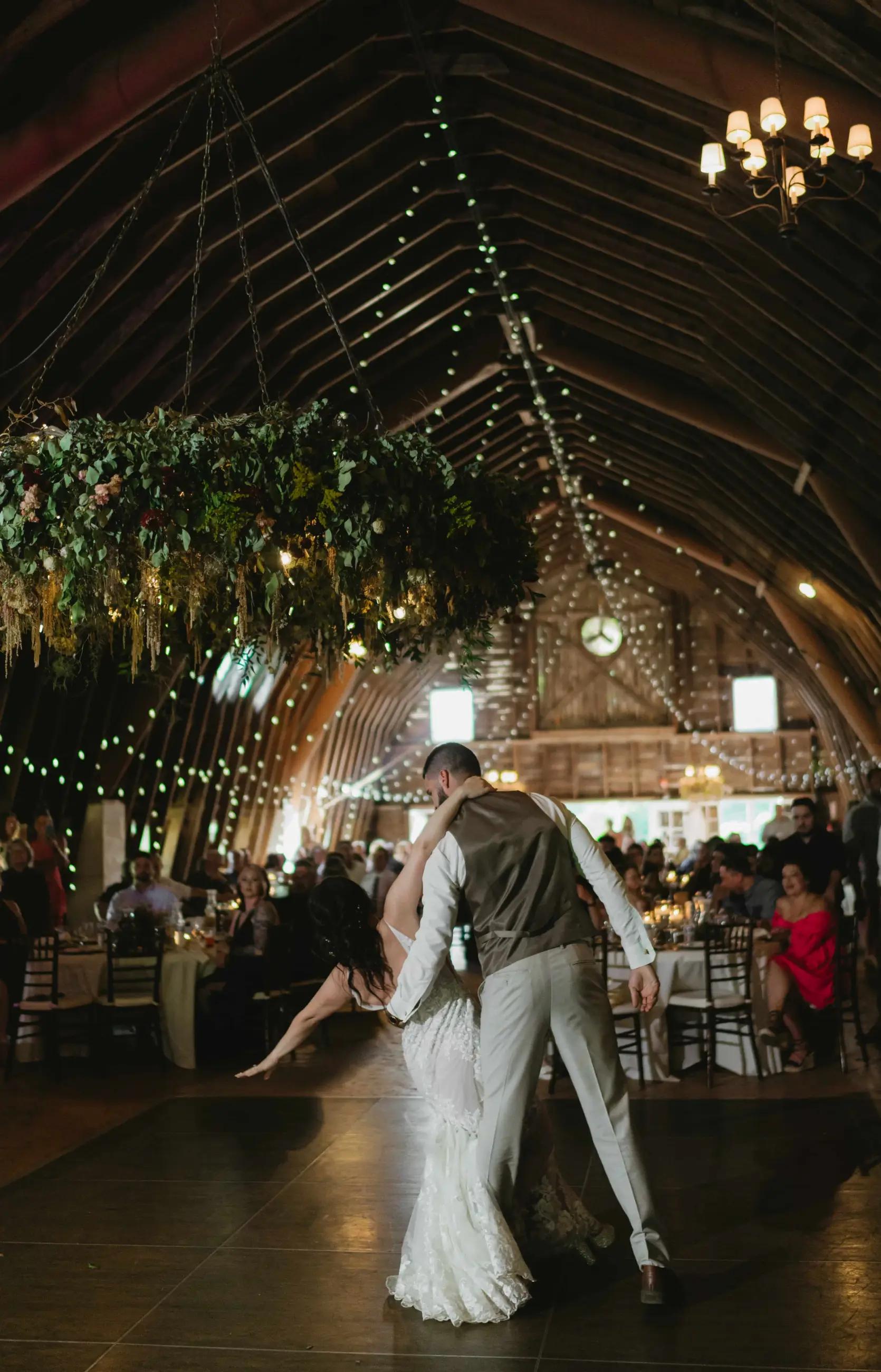 indoor wedding photo of bride and groom dancing and kissing